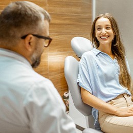 Female patient smiling at dentist at dental appointment