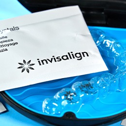 Patient in Huntington cleaning their Invisalign aligners