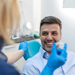 Patient in Huntington smiling with orthodontist at Invisalign check-in