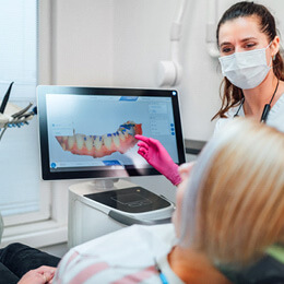 an orthodontist showing their patient their digital scan