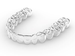 Clear aligner tray on a white surface